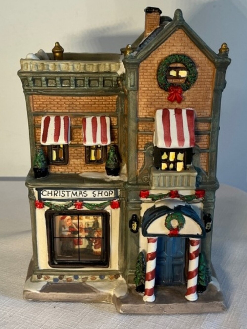 Christmas Shop Store village building with illuminated window.